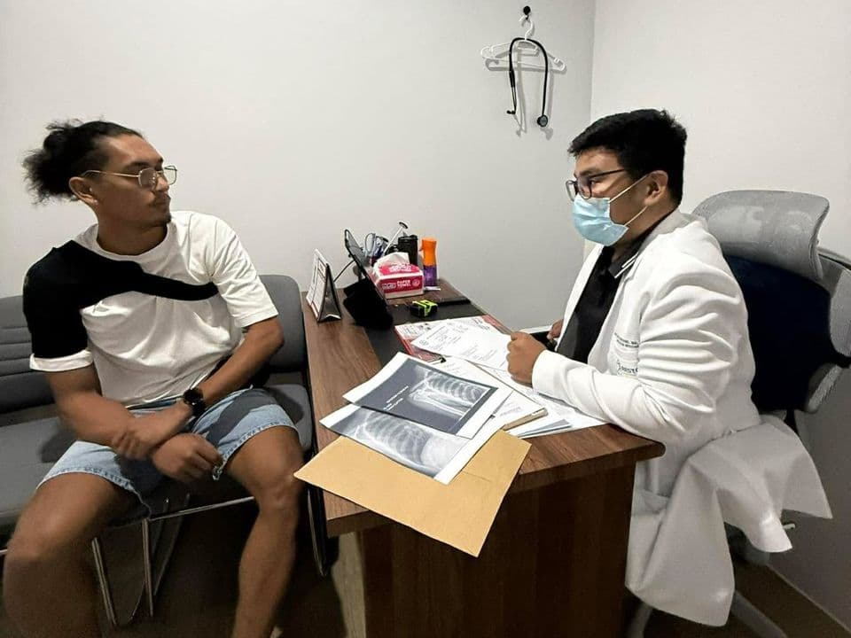 Doctor going over a patient's X-rays during a consultation